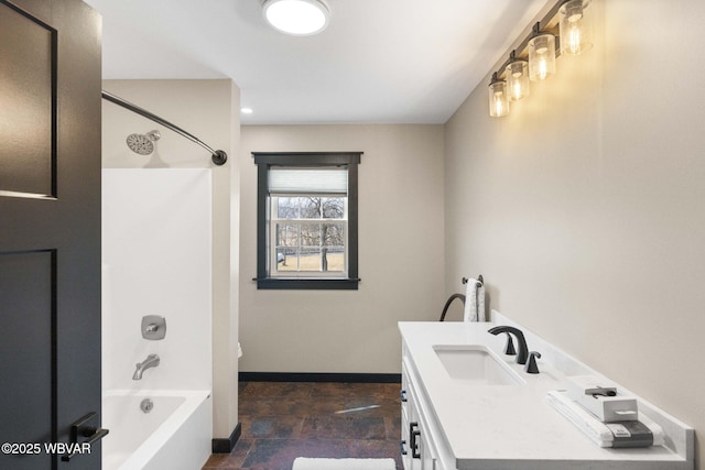 full bath with stone finish flooring, baseboards, bathing tub / shower combination, and vanity