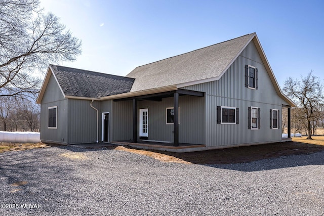 modern farmhouse style home featuring roof with shingles