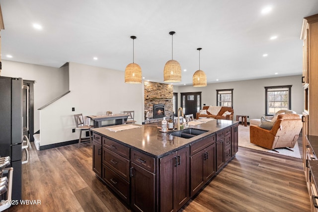 kitchen featuring a sink, dark wood-type flooring, open floor plan, and freestanding refrigerator