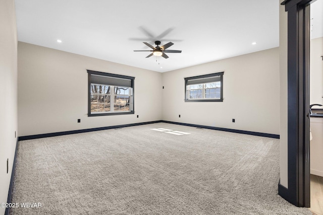 carpeted spare room with recessed lighting, a ceiling fan, and baseboards