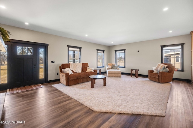 living area featuring recessed lighting, baseboards, and dark wood-style flooring