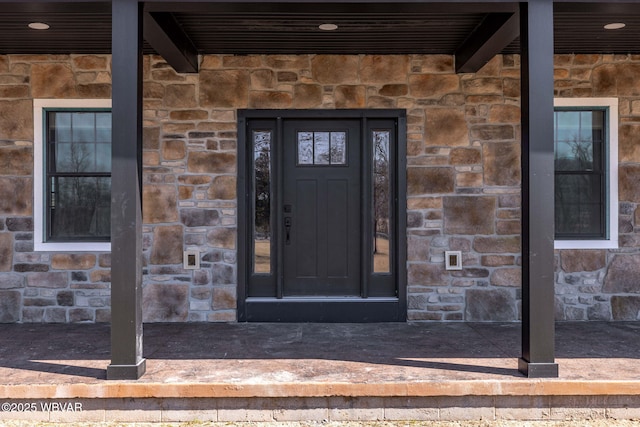 view of exterior entry with stone siding