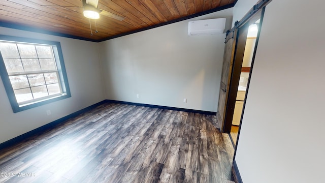 empty room with wooden ceiling, ceiling fan, a barn door, dark hardwood / wood-style flooring, and a wall unit AC