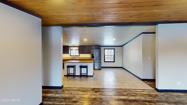 kitchen featuring tile patterned floors, butcher block counters, stainless steel refrigerator with ice dispenser, and wood ceiling