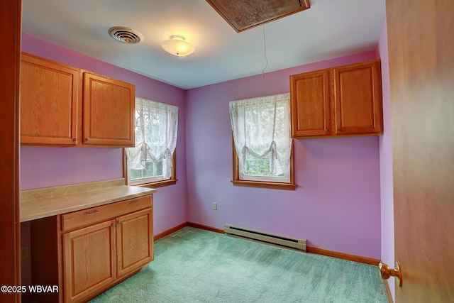 43 Hillcrest Ln, Williamsport, PA 17701 - kitchen featuring a baseboard heating unit, light countertops, light colored carpet, and brown cabinets