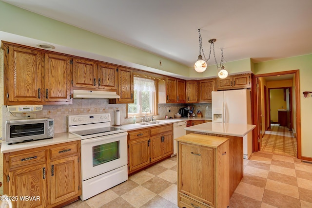 43 Hillcrest Ln, Williamsport, PA 17701 - kitchen featuring white appliances, under cabinet range hood, a kitchen island, light countertops, and decorative backsplash