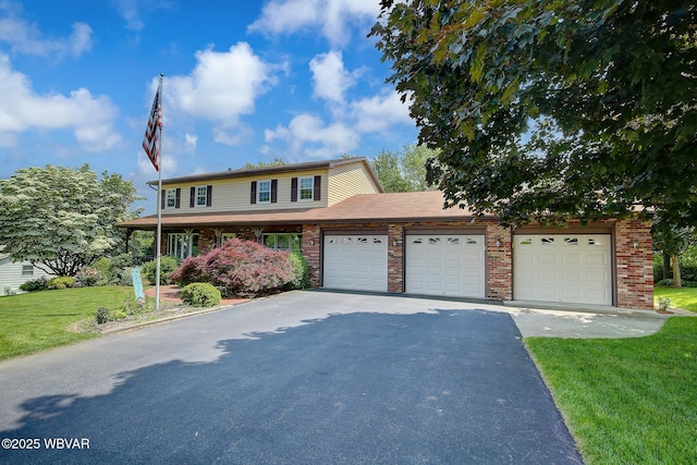 43 Hillcrest Ln, Williamsport, PA 17701 - view of front facade featuring a front yard, brick siding, driveway, and an attached garage