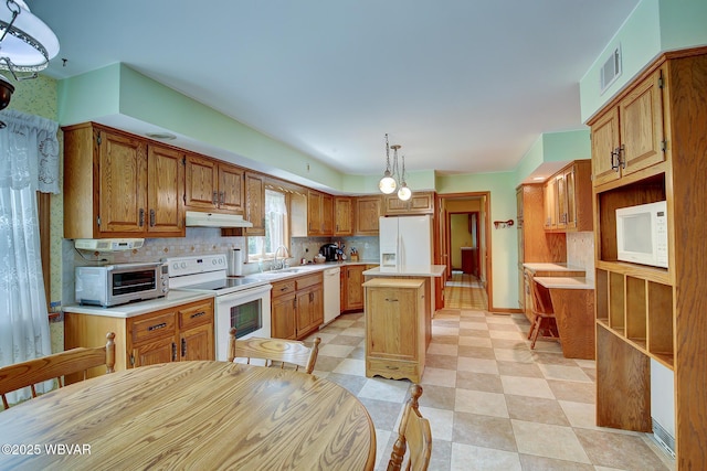 43 Hillcrest Ln, Williamsport, PA 17701 - kitchen featuring white appliances, under cabinet range hood, a center island, light countertops, and decorative backsplash