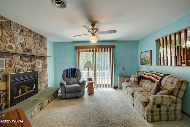 43 Hillcrest Ln, Williamsport, PA 17701 - living room with carpet floors, a ceiling fan, and a stone fireplace