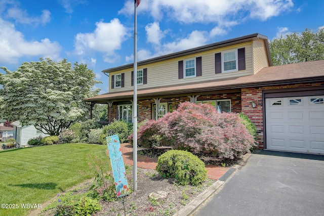 43 Hillcrest Ln, Williamsport, PA 17701 - view of front of home featuring a front yard, brick siding, a garage, and a porch