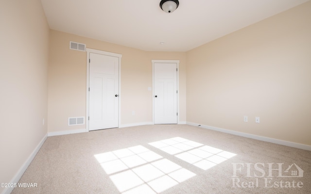 unfurnished bedroom featuring carpet, visible vents, and baseboards