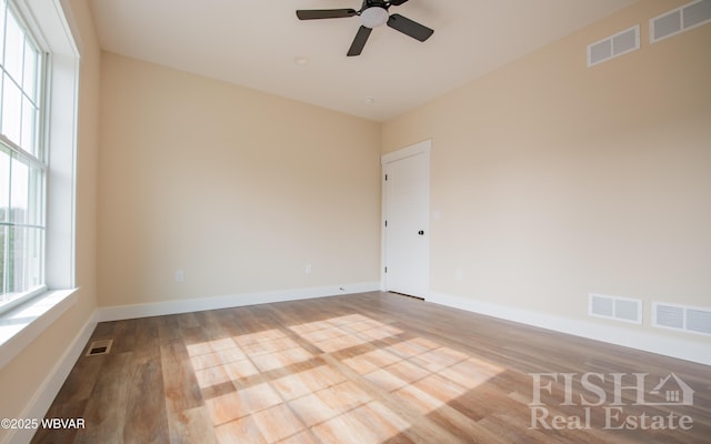 spare room featuring visible vents and light wood finished floors