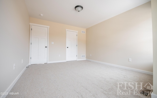 unfurnished bedroom with light colored carpet, visible vents, and baseboards