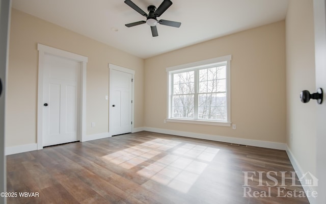 unfurnished bedroom with visible vents, ceiling fan, light wood-style flooring, and baseboards