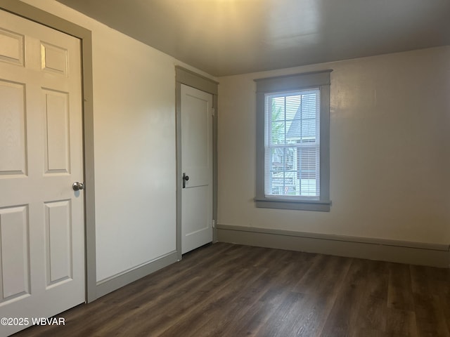 2401 Linn St, Williamsport, PA 17701 - unfurnished bedroom with dark wood-style flooring and baseboards