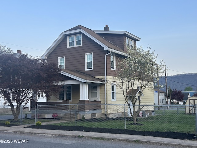 2401 Linn St, Williamsport, PA 17701 - view of front of house featuring covered porch, a fenced front yard, a chimney, and a front yard
