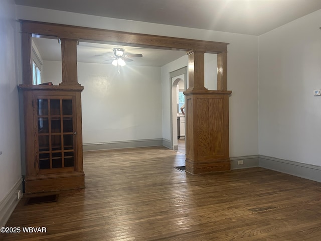 2401 Linn St, Williamsport, PA 17701 - unfurnished living room featuring arched walkways, baseboards, ceiling fan, and hardwood / wood-style flooring