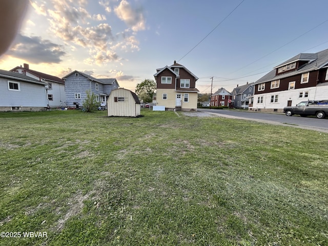 2401 Linn St, Williamsport, PA 17701 - yard at dusk with an outbuilding, a residential view, and a shed