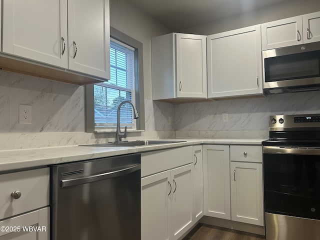 2401 Linn St, Williamsport, PA 17701 - kitchen with a sink, white cabinets, and appliances with stainless steel finishes