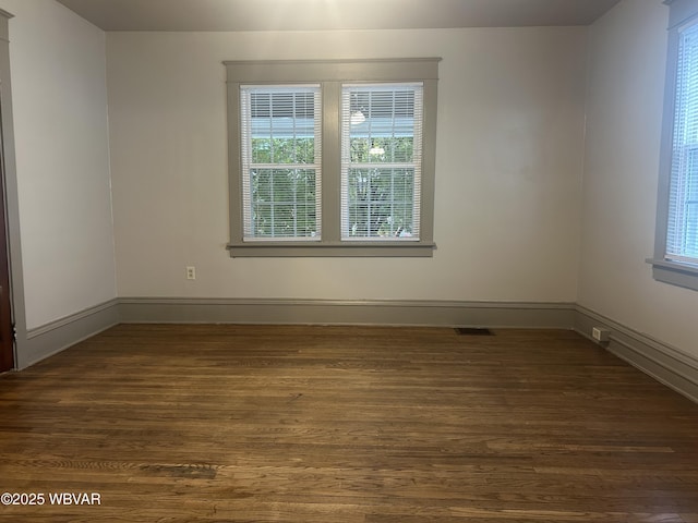 2401 Linn St, Williamsport, PA 17701 - empty room with plenty of natural light, dark wood-style flooring, and baseboards
