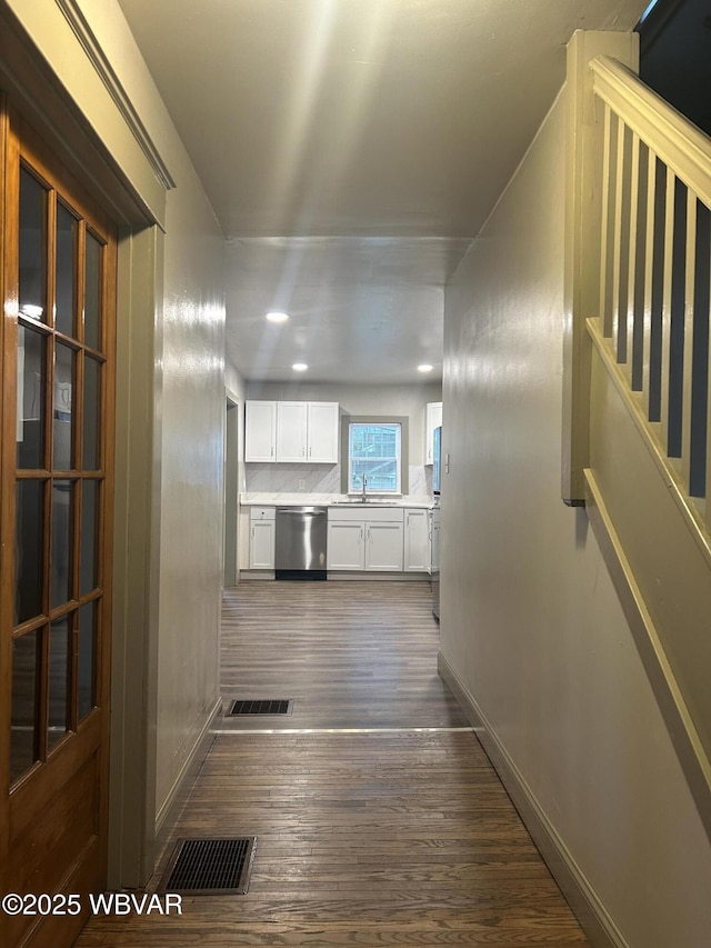 2401 Linn St, Williamsport, PA 17701 - corridor with baseboards, dark wood-style floors, visible vents, and a sink