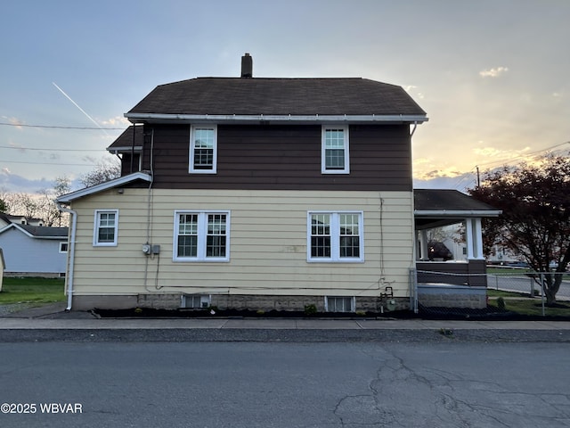2401 Linn St, Williamsport, PA 17701 - view of side of property featuring a shingled roof, fence, and a chimney