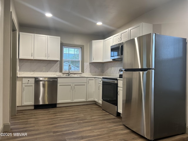 2401 Linn St, Williamsport, PA 17701 - kitchen with a sink, dark wood-type flooring, white cabinetry, light countertops, and appliances with stainless steel finishes