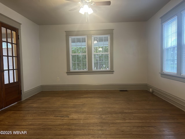 2401 Linn St, Williamsport, PA 17701 - spare room with baseboards, visible vents, ceiling fan, and dark wood-style floors