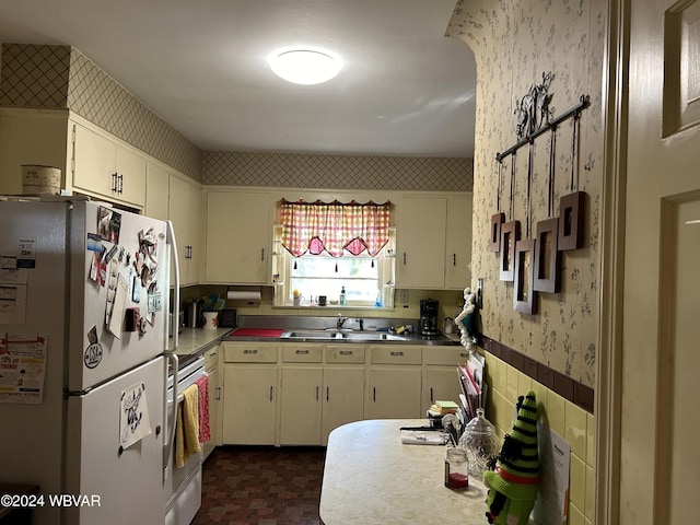 kitchen featuring white refrigerator, stainless steel stove, stainless steel counters, and sink