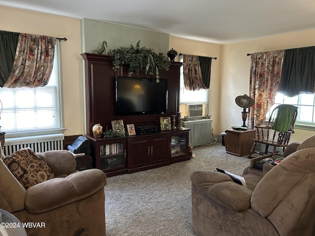 living room with a wealth of natural light, radiator heating unit, and light colored carpet