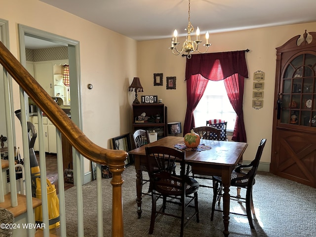 carpeted dining space featuring an inviting chandelier