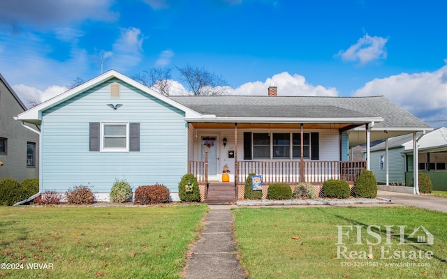 view of front of home with covered porch and a front yard