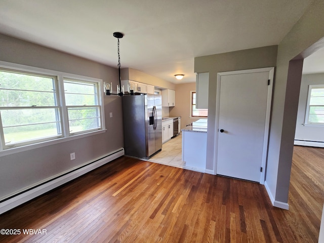 1760 Fredna Ave, Williamsport, PA 17701 - kitchen featuring stainless steel appliances, a baseboard heating unit, white cabinets, a chandelier, and light wood-type flooring