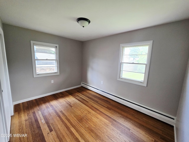 1760 Fredna Ave, Williamsport, PA 17701 - spare room with healthy amount of natural light, a baseboard heating unit, wood finished floors, and baseboards