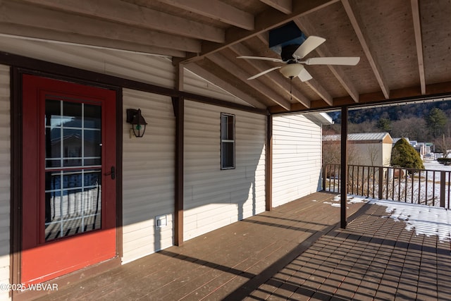 wooden terrace featuring ceiling fan