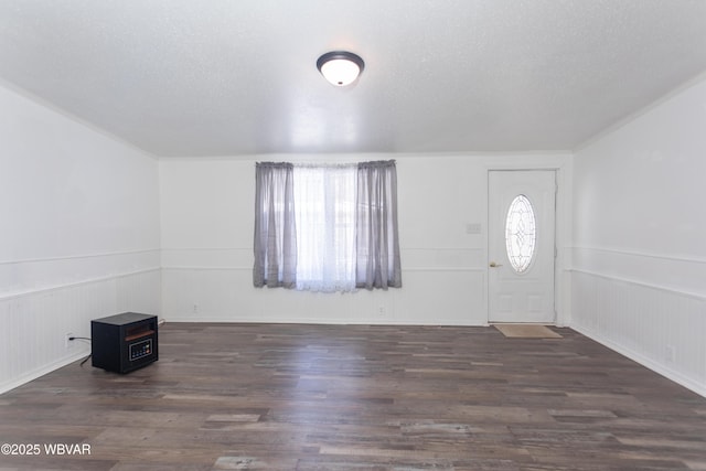 foyer with dark wood-type flooring and a textured ceiling