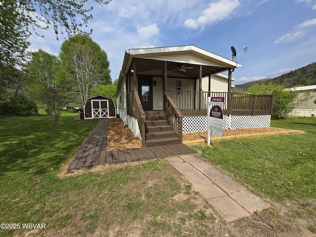 140 Bittners Park Rd, Trout Run, PA 17771 - view of front of home with a ceiling fan, an outdoor structure, a front yard, a porch, and a storage unit