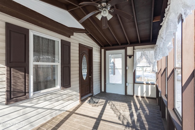 unfurnished sunroom featuring wood ceiling, ceiling fan, and lofted ceiling