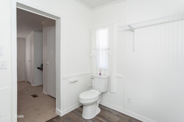 bathroom with toilet and hardwood / wood-style floors