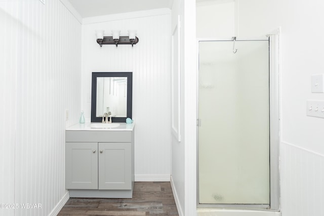 bathroom featuring hardwood / wood-style flooring, vanity, and an enclosed shower