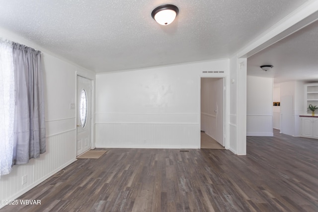 interior space featuring dark hardwood / wood-style floors and a textured ceiling