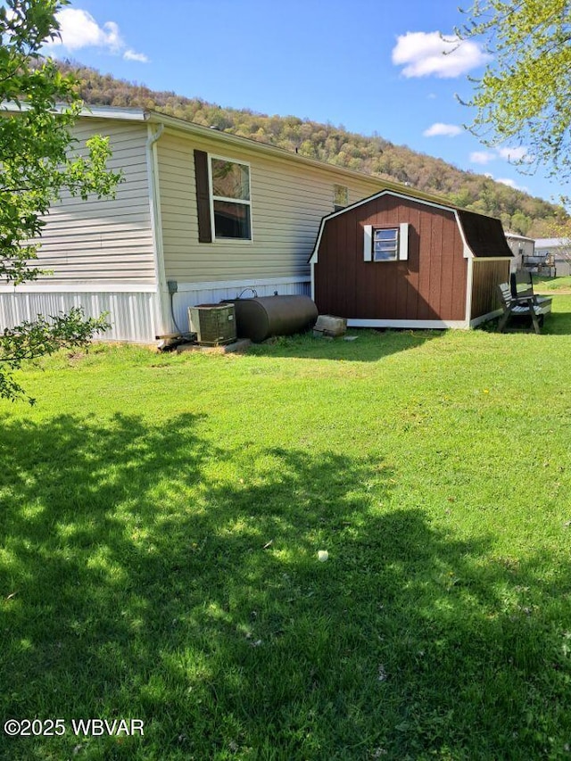 140 Bittners Park Rd, Trout Run, PA 17771 - back of house featuring an outdoor structure, a lawn, and a storage unit