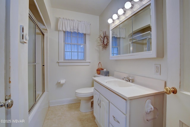 bathroom featuring baseboards, vanity, toilet, and bath / shower combo with glass door