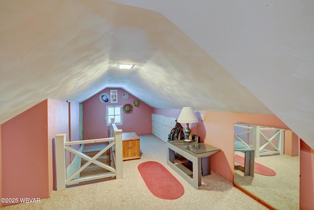 interior space featuring lofted ceiling and light carpet