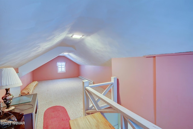 bonus room with a baseboard radiator, carpet, and vaulted ceiling