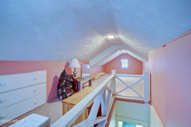 bedroom featuring lofted ceiling and light carpet