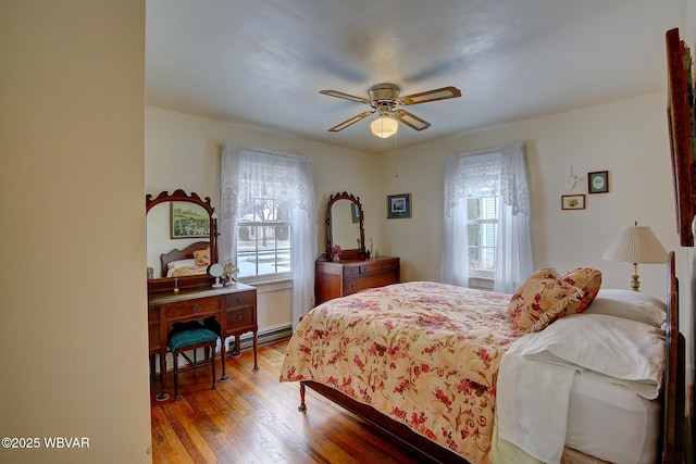 bedroom with ceiling fan and light wood-style flooring