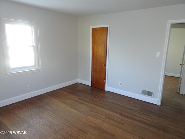 empty room with dark hardwood / wood-style floors