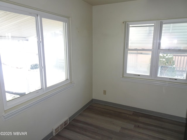 unfurnished room with dark hardwood / wood-style flooring