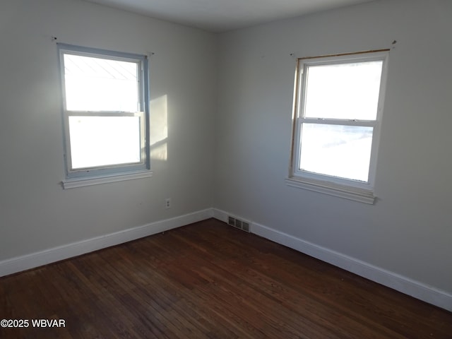 empty room with dark hardwood / wood-style floors